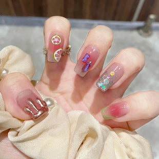 Shiny diamond fragments and fresh lemon nail polish