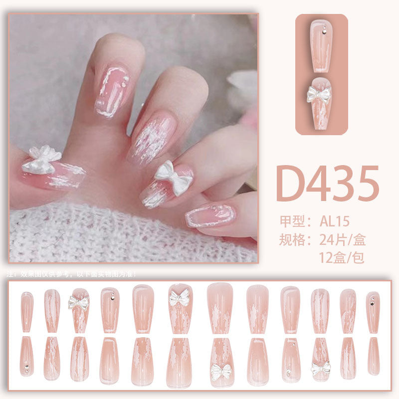 Young girl's pink and white bow-shaped nail polish