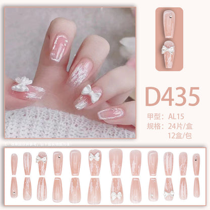 Young girl's pink and white bow-shaped nail polish