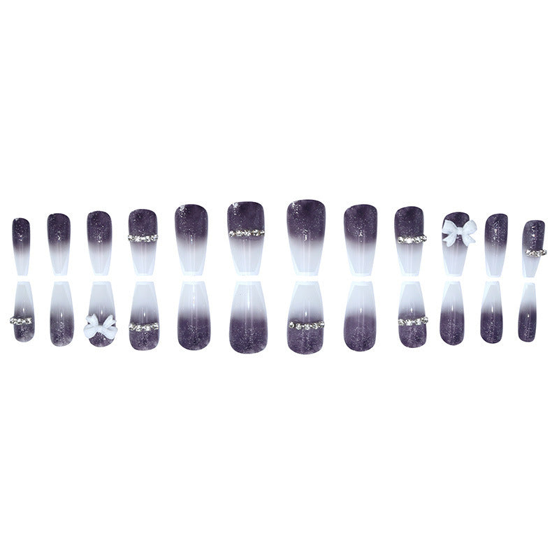 Long-length ballet-style nail chain with diamond-studded bow-shaped embellishment nail art