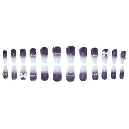 Long-length ballet-style nail chain with diamond-studded bow-shaped embellishment nail art