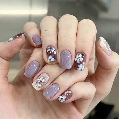 Simple square-shaped nail polish with purple flowers and a beautiful design