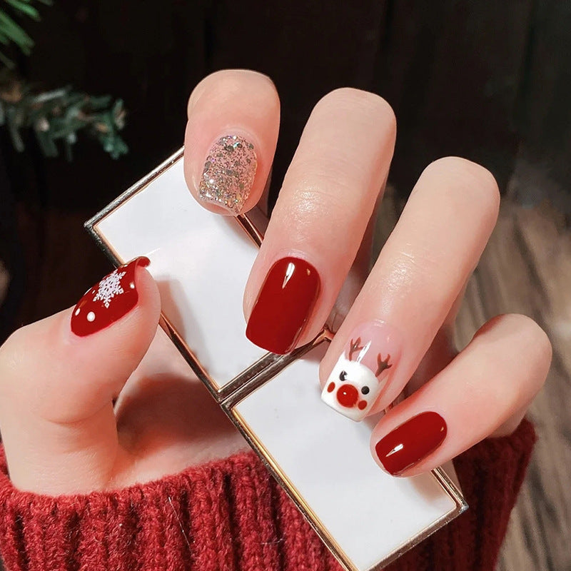 Golden flashing Christmas cartoon deer with painted nails