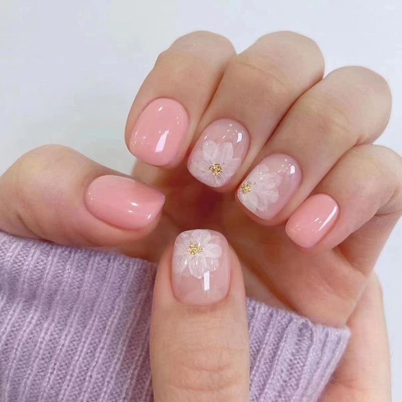 Nude-colored flowers adorned with nails