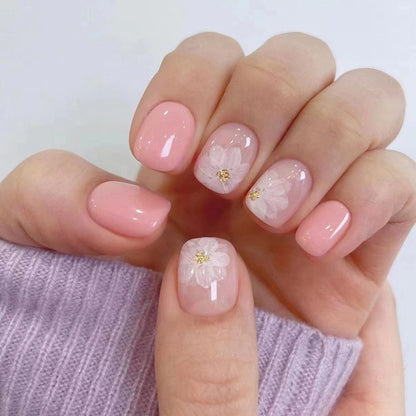 Nude-colored flowers adorned with nails
