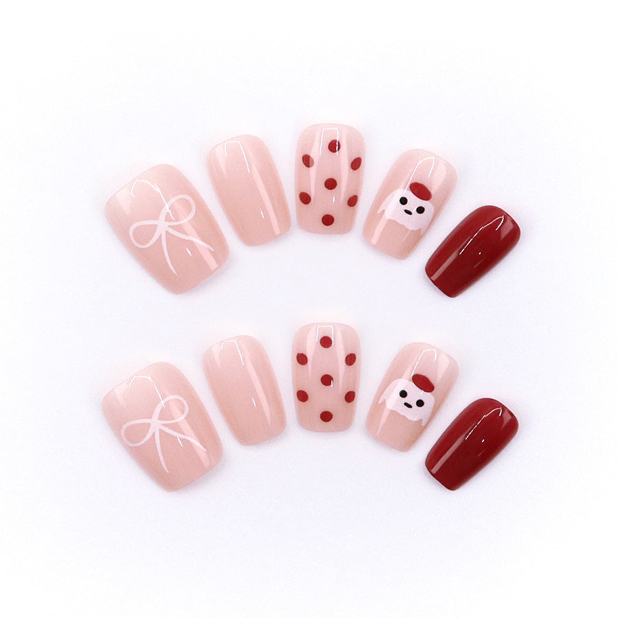 Red polka-dot hat, cute puppy, beautiful nails