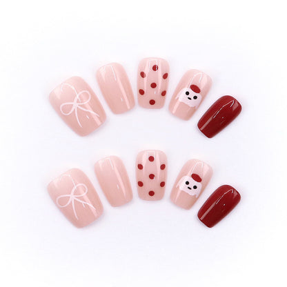Red polka-dot hat, cute puppy, beautiful nails