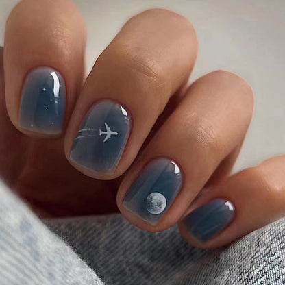 Dark blue aircraft wearing lunar-themed nails