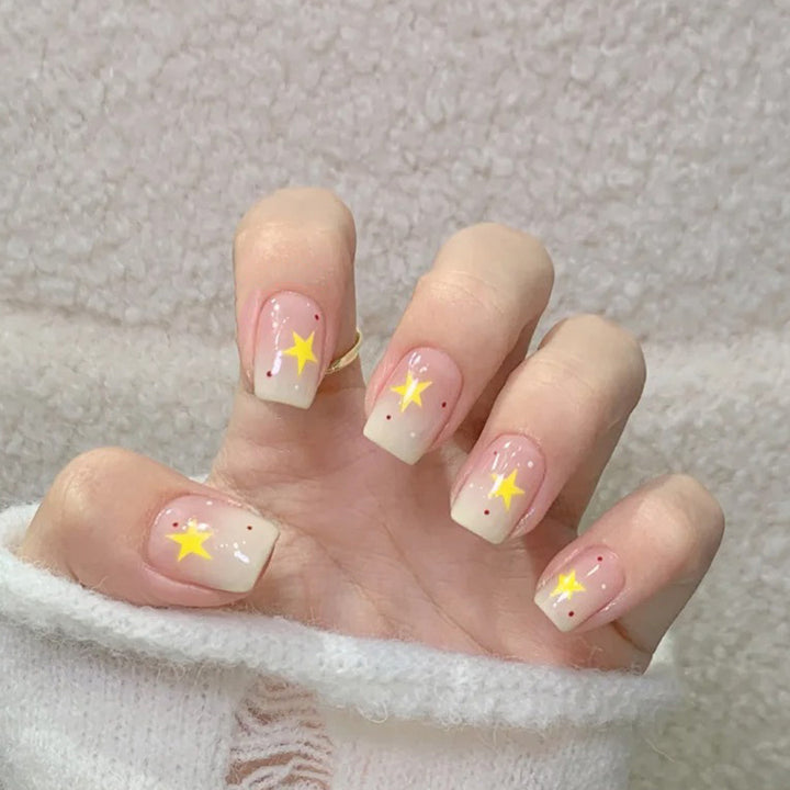 Cream-colored gradient yellow star nail polish