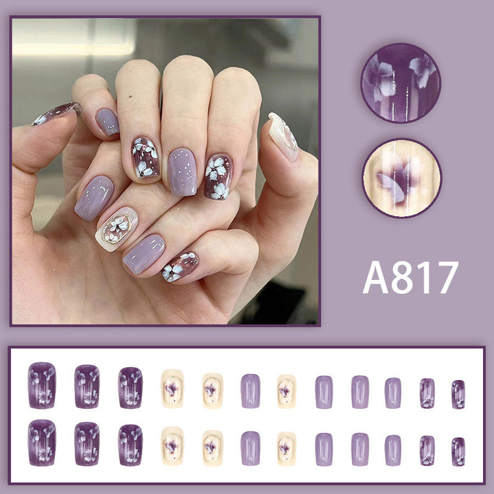 Simple square-shaped nail polish with purple flowers and a beautiful design