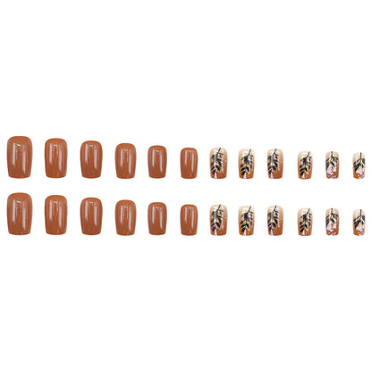 Caramel-colored leaves and gold foil manicure