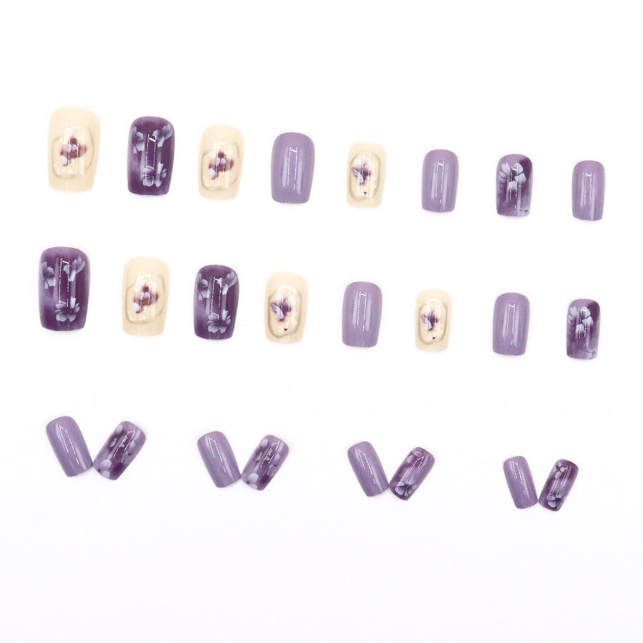 Simple square-shaped nail polish with purple flowers and a beautiful design