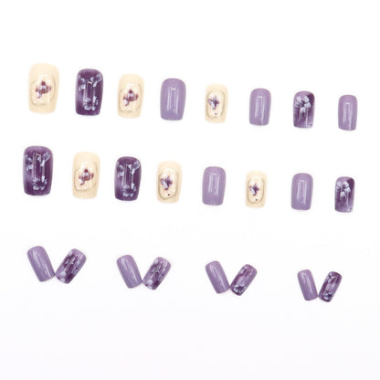 Simple square-shaped nail polish with purple flowers and a beautiful design