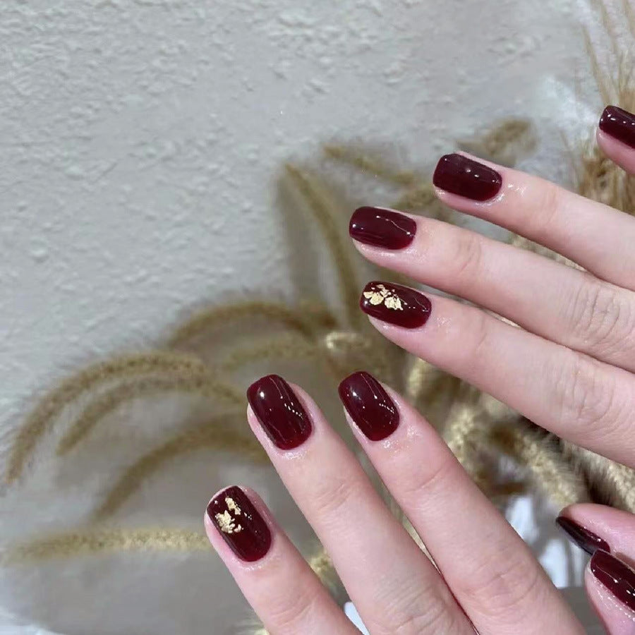 Anclara's red manicured nails