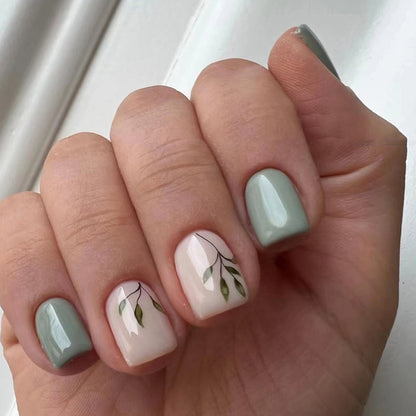 Tea-colored green leaves with painted nails
