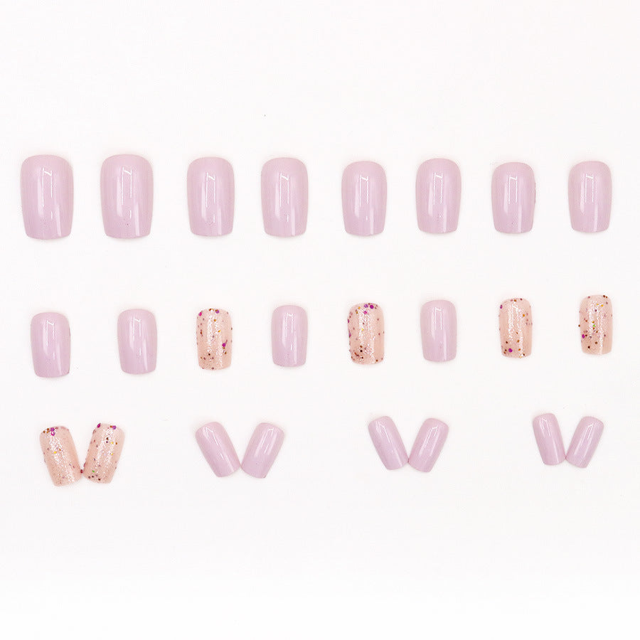 Pink glitter powder applied to nails