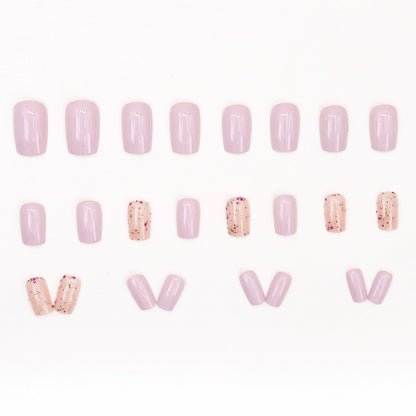 Pink glitter powder applied to nails