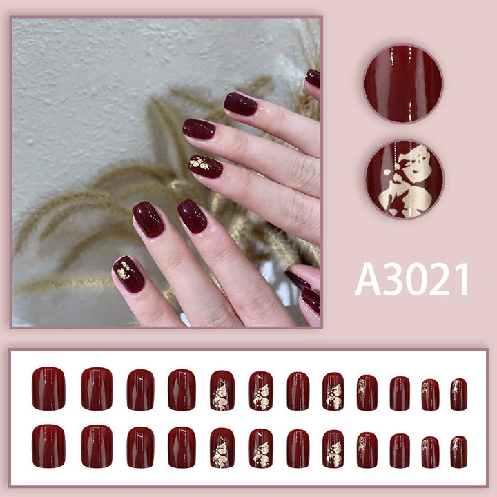 Anclara's red manicured nails
