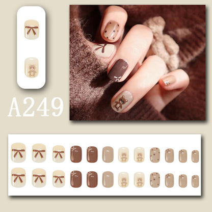 Coffee bow tie teddy bear wearing nail polish