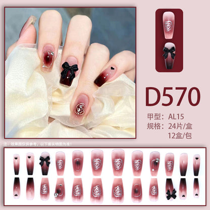 Black bow-shaped rhinestone decoration on the nails of the tea flower style nails