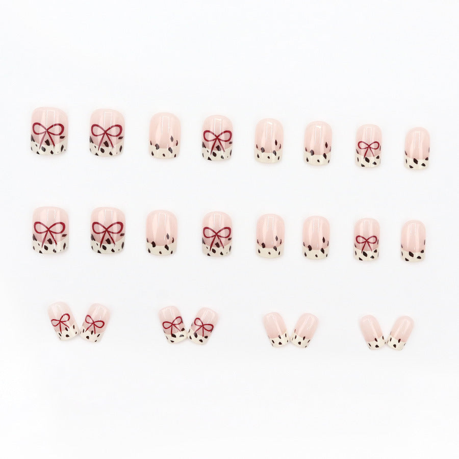 Bare color powder bow leopard print nail art
