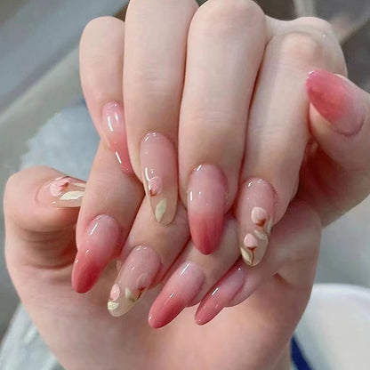 The peach-pink color is gradually applied to the nails.