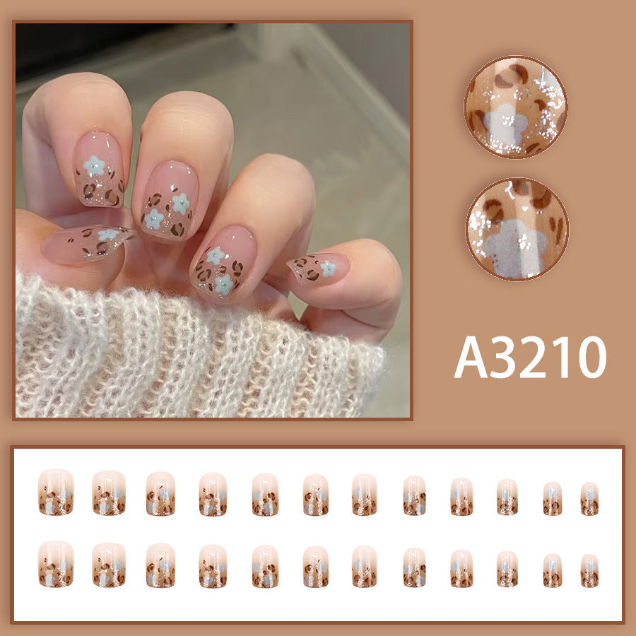 Tattoo of a blooming orchid with leopard print on the nails