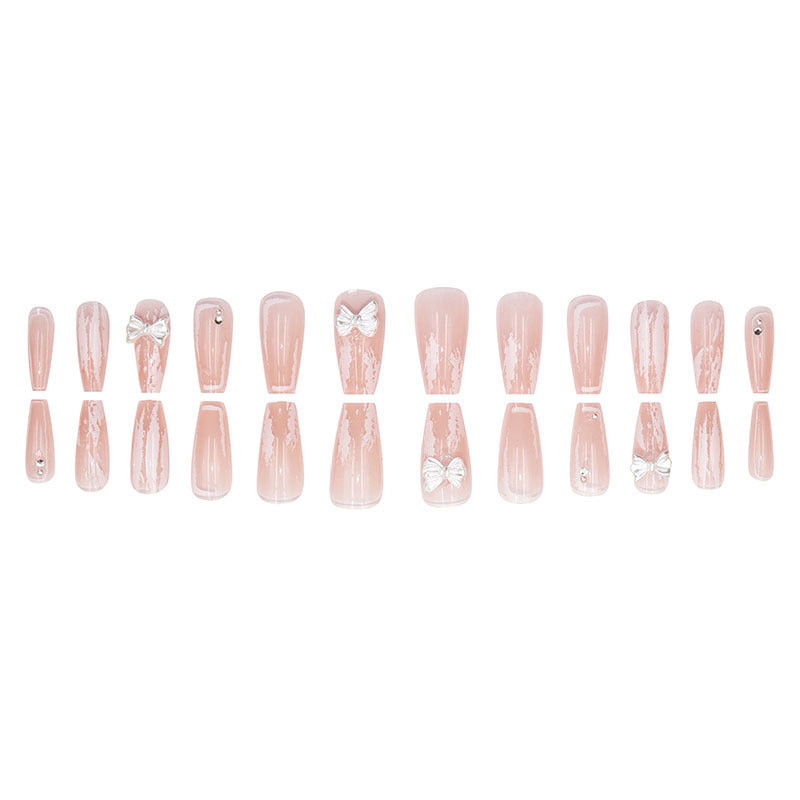 Young girl's pink and white bow-shaped nail polish