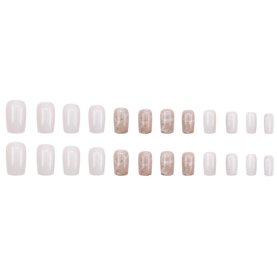 Applying gold foil powder to the nails for a smoky effect