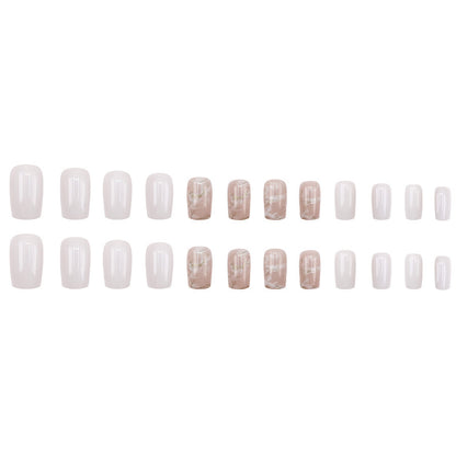 Applying gold foil powder to the nails for a smoky effect