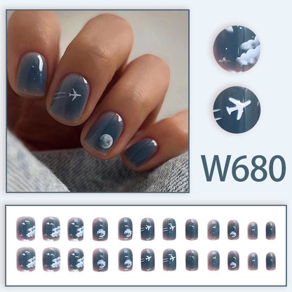 Dark blue aircraft wearing lunar-themed nails