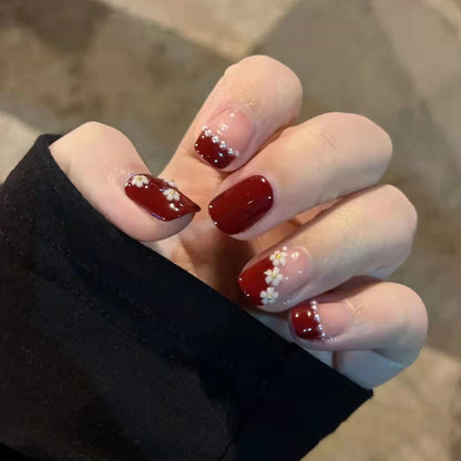 Red and white pearl-shaped small flowers worn as nail decorations