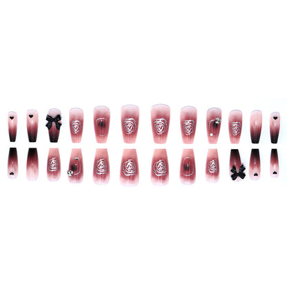 Black bow-shaped rhinestone decoration on the nails of the tea flower style nails