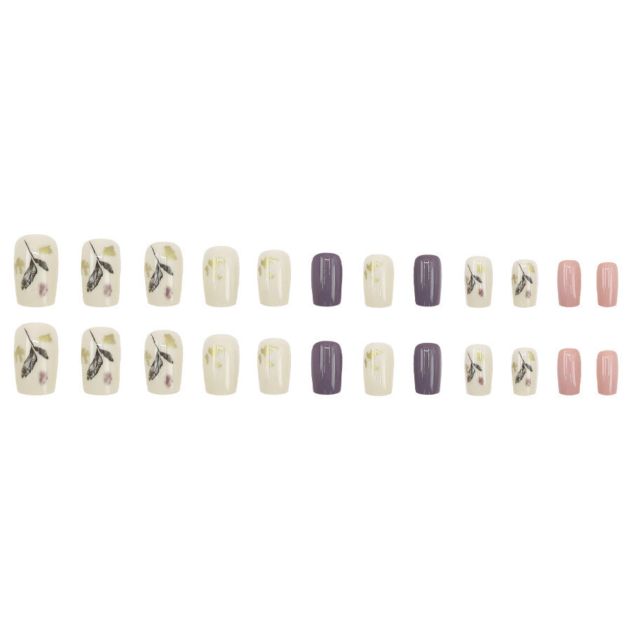Leaves adorning gold foil manicure
