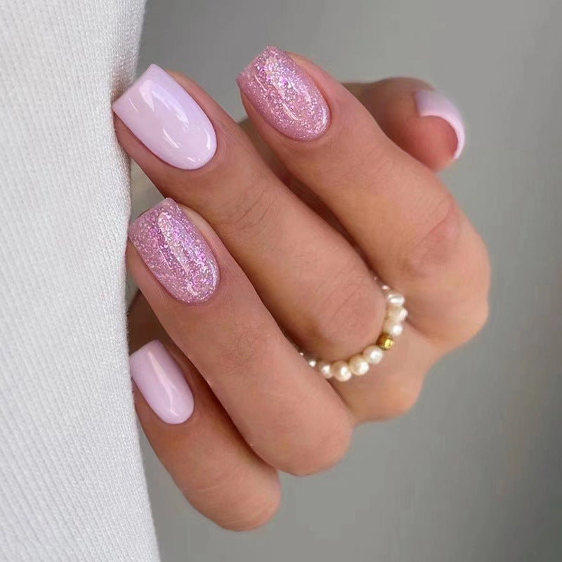 Pink glitter powder applied to nails