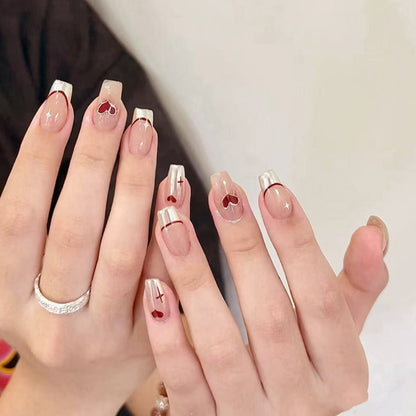 Red heart-shaped ballet shoes with nail polish
