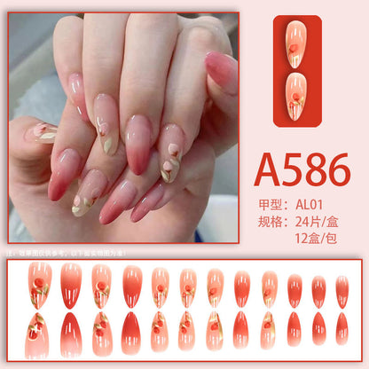 The peach-pink color is gradually applied to the nails.