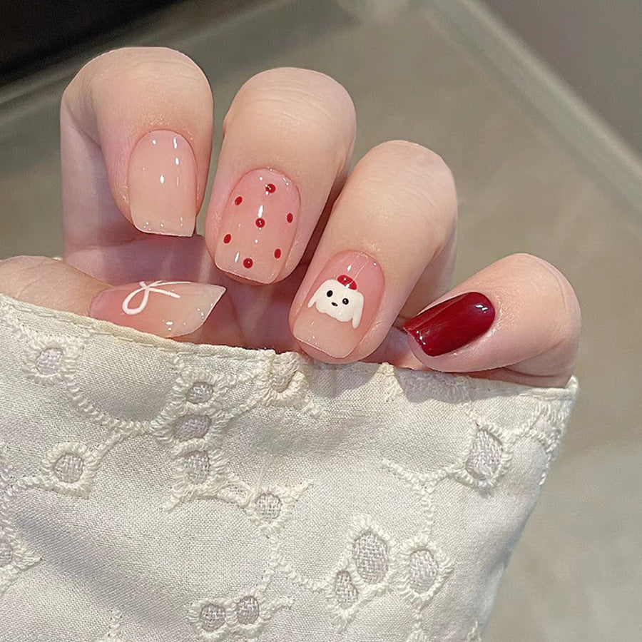 Red polka-dot hat, cute puppy, beautiful nails