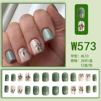 Tea-colored green leaves with painted nails