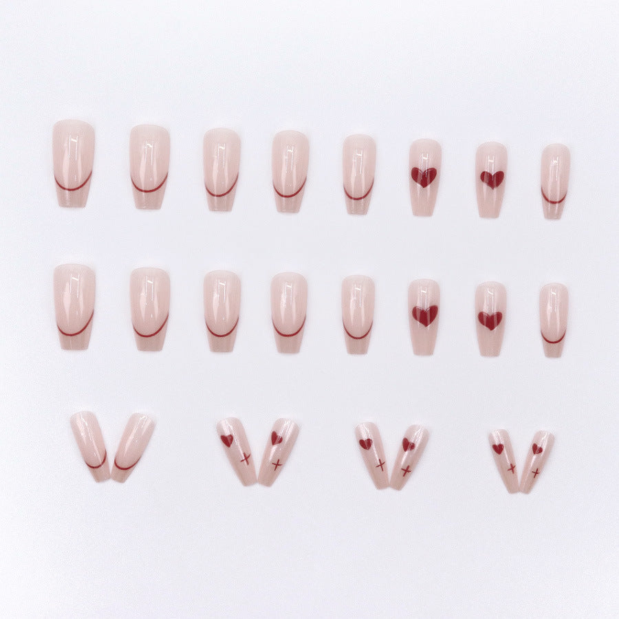 Red heart-shaped ballet shoes with nail polish