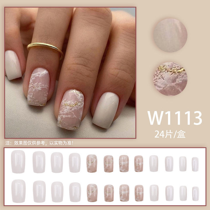 Applying gold foil powder to the nails for a smoky effect