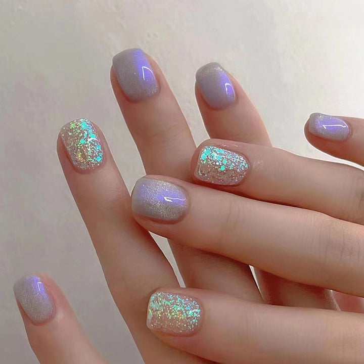 Glitter sprinkled on purple spots for nail decoration
