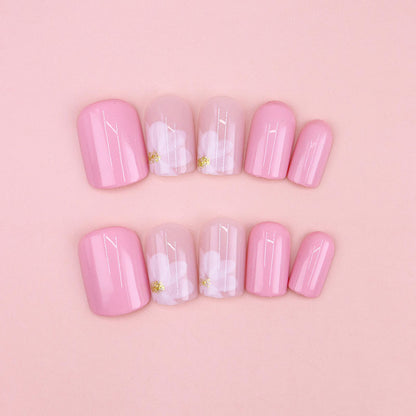Nude-colored flowers adorned with nails