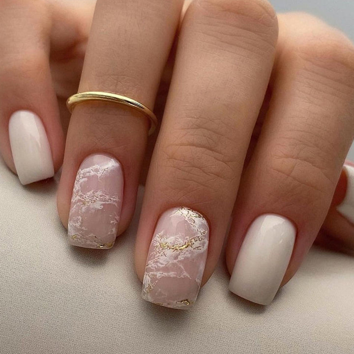 Applying gold foil powder to the nails for a smoky effect
