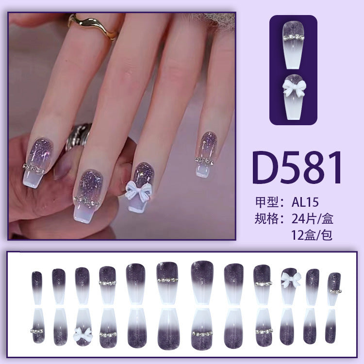 Long-length ballet-style nail chain with diamond-studded bow-shaped embellishment nail art