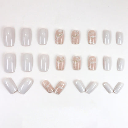 Applying gold foil powder to the nails for a smoky effect