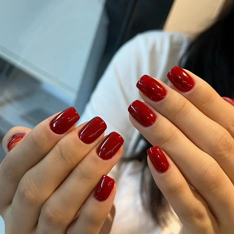 Pure red-toned attire with nail polish