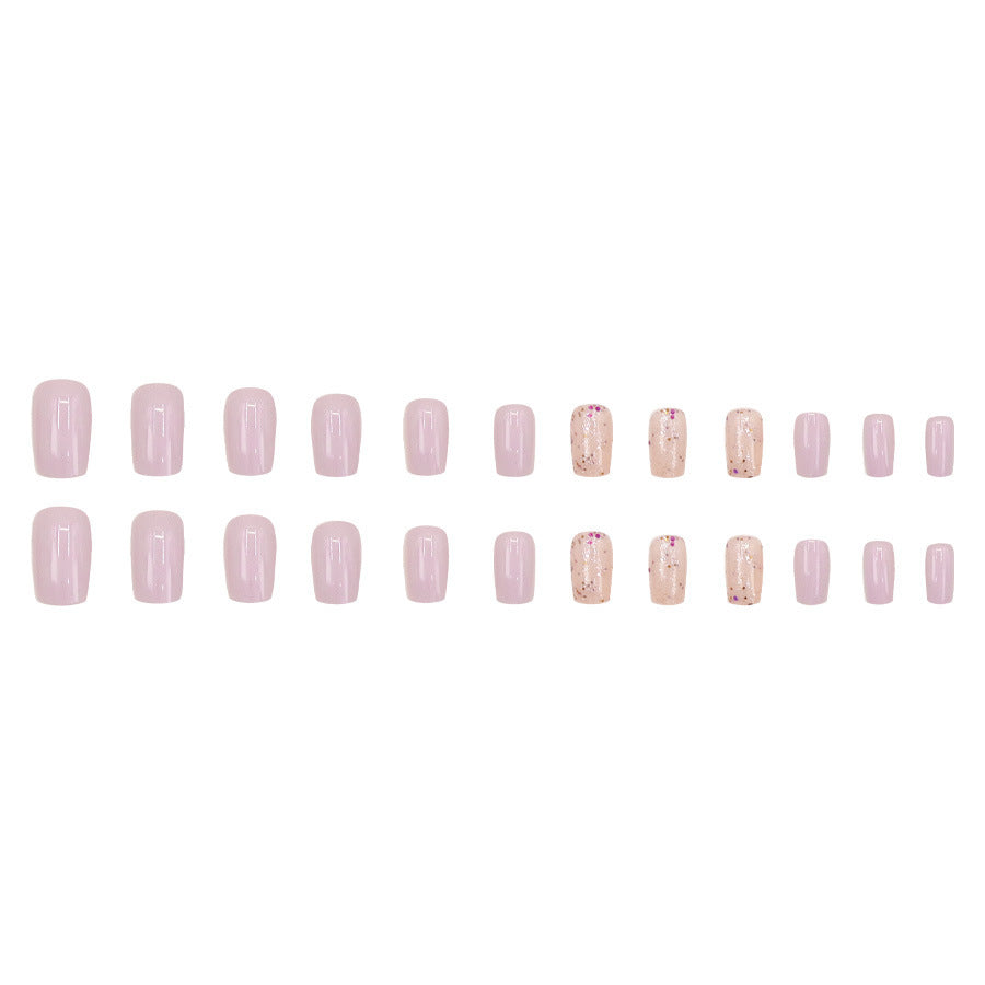 Pink glitter powder applied to nails