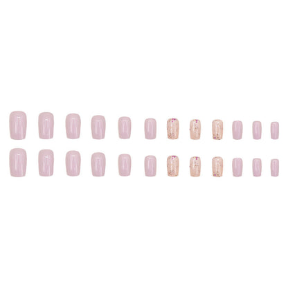 Pink glitter powder applied to nails