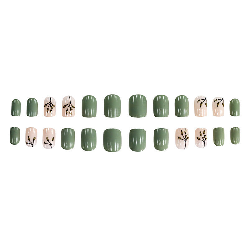 Tea-colored green leaves with painted nails